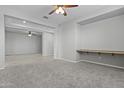 Open concept living space featuring a built-in desk and plush carpeting at 29302 N 126Th Ln, Peoria, AZ 85383
