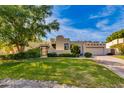 Charming home showcasing lush landscaping, mature trees, and beautiful Southwestern architecture at 3186 E Stella Ln, Phoenix, AZ 85016