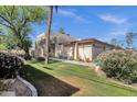 Exterior view of the home featuring a well-maintained lawn and desert landscaping at 3221 N 37Th St # 10, Phoenix, AZ 85018