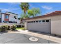 Home exterior featuring a garage with a gray door and desert landscaping at 3221 N 37Th St # 10, Phoenix, AZ 85018