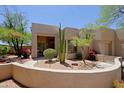 Single-story Southwestern home featuring a walled front yard with desert landscaping at 32516 N 68Th Pl, Scottsdale, AZ 85266
