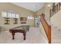Bright and airy game room with a pool table, staircase, and a cozy ambiance for Gathering fun at 3859 N El Sereno St, Mesa, AZ 85207
