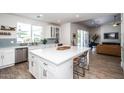 Bright, modern kitchen featuring a large island, stainless steel appliances, and an open view to the living space at 4124 E Indianola Ave, Phoenix, AZ 85018