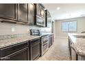 A close up view of the kitchen with stainless steel appliances and granite countertops at 4277 N 180Th Ln, Goodyear, AZ 85395