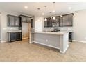 A kitchen showcasing an island, granite countertops, and dark wood cabinets at 4277 N 180Th Ln, Goodyear, AZ 85395