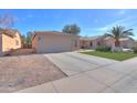 Charming single-story home featuring a two-car garage, desert landscaping and long driveway at 43935 W Sagebrush Trl, Maricopa, AZ 85138