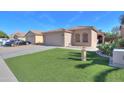 Charming single-story home featuring a two-car garage and well-maintained artificial lawn at 43935 W Sagebrush Trl, Maricopa, AZ 85138