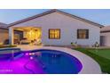 Inviting pool and covered patio create a relaxing backyard oasis with manicured desert landscaping at 4593 W Bush Bean Way, San Tan Valley, AZ 85144