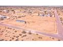 Bird's eye view of a fenced property featuring a single-story home in a sprawling desert community at 47654 W Venado Rd, Maricopa, AZ 85139