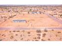 Aerial view of a single-story home on a spacious lot with a chain-link fence in a rural area at 47654 W Venado Rd, Maricopa, AZ 85139