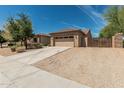 Charming single-story home with desert landscaping, driveway, and a two-car garage at 5232 N 186Th Dr, Litchfield Park, AZ 85340