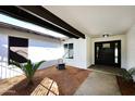 Inviting front entry featuring a modern door, desert landscaping, and ample natural light at 6254 E Winchcomb Dr, Scottsdale, AZ 85254