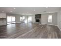 Spacious living room boasting a fireplace, wood-look floors, and ample natural light at 6254 E Winchcomb Dr, Scottsdale, AZ 85254
