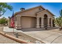 Charming home with a covered entryway, desert landscaping, and an American flag at 6621 S Coral Gable Dr, Chandler, AZ 85249