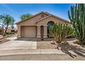 Charming home with desert landscaping and a covered entryway on a sunny day at 6621 S Coral Gable Dr, Chandler, AZ 85249