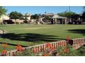 Expansive park with grassy area, playground, ramada and lush landscaping, perfect for outdoor activities at 742 E Kyle Dr, Gilbert, AZ 85296