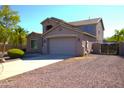 Side view of two-story home showing garage and side yard with mature landscaping at 8920 S 40Th Ln, Laveen, AZ 85339