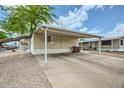 Spacious carport offering covered parking and shade, with low-maintenance landscaping at 9431 E Coralbell Ave # Ofc, Mesa, AZ 85208
