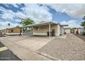 Single-story home featuring a covered carport, storage, and low-maintenance desert landscaping at 9431 E Coralbell Ave # Ofc, Mesa, AZ 85208