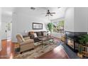 Comfortable living room with a plush sofa, fireplace, and large windows providing ample natural light at 9550 E Thunderbird Rd # 214, Scottsdale, AZ 85260