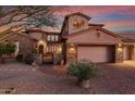 An elegant home with a paver driveway, a gated courtyard, and lush desert landscaping at 9753 E Suncrest Rd, Scottsdale, AZ 85262