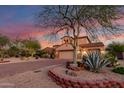 Beautiful home with desert landscaping, a paver driveway, and a majestic tree at 9753 E Suncrest Rd, Scottsdale, AZ 85262