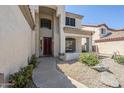 Welcoming front entrance with covered porch and path lined with flowering plants at 1031 W Longhorn Dr, Chandler, AZ 85286