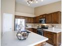 Kitchen with stainless steel appliances and a white countertop island at 10845 W Quail Ave, Peoria, AZ 85373