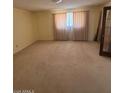 Spacious bedroom filled with light, neutral carpet, and large window at 121 E Ivanhoe St, Gilbert, AZ 85295