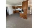 Traditional kitchen with wood cabinets, complete with black appliances at 121 E Ivanhoe St, Gilbert, AZ 85295