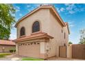 Exterior view of a home with a two-car garage and a well-maintained lawn with nice shrubbery at 1231 W Mediterranean Dr, Gilbert, AZ 85233