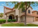 Inviting exterior of two-story home featuring manicured lawn with mature landscaping and a two-car garage at 1231 W Mediterranean Dr, Gilbert, AZ 85233