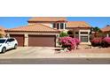 Inviting home featuring a well-manicured yard and attached two-car garage with a tile roof at 14021 N 29Th St, Phoenix, AZ 85032