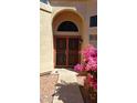 Close-up of an arched front door with decorative security gate and bougainvillea at 14021 N 29Th St, Phoenix, AZ 85032