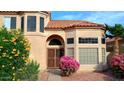 Inviting front entrance with a wrought iron security door and colorful landscaping at 14021 N 29Th St, Phoenix, AZ 85032