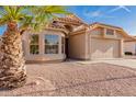 Single Gathering home with large window and two-car garage, landscaping with desert rock and a terracotta roof at 1627 W Maplewood St, Chandler, AZ 85286