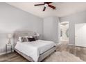 Bedroom features a large bed, ceiling fan, and ensuite bathroom with a shower at 1925 W Olive Way, Chandler, AZ 85248