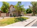 Charming home with a well-manicured lawn and a stone-accented entrance, featuring a two-car garage at 1925 W Olive Way, Chandler, AZ 85248