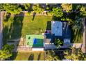 Expansive backyard featuring lush landscaping, full sport court, and covered patio with entertaining space at 2350 E Melrose St, Gilbert, AZ 85297
