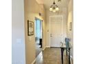 Inviting entryway features neutral walls, tile flooring, and stylish light fixture, enhancing the home's appeal at 2422 W Maya Way, Phoenix, AZ 85085