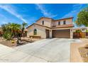 Charming two-story home showcasing a three-car garage and well-maintained desert landscaping at 2460 E Crescent Way, Gilbert, AZ 85298