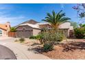 Tan single-story home with tile roof, a two-car garage, and desert landscaping at 24813 N 55Th Dr, Glendale, AZ 85310