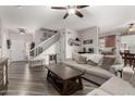 Spacious living room with wood floors and staircase, blending comfort and style at 34913 N 30Th Dr, Phoenix, AZ 85086