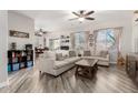 Comfortable living room with wood floors and large windows, providing ample natural light at 34913 N 30Th Dr, Phoenix, AZ 85086