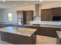 Open concept kitchen with granite countertops, stainless steel appliances, and a central island at 3811 S Bridlewood Ave, Mesa, AZ 85212