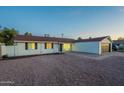 Charming single-story home with a two-car garage, desert landscaping and blue skies at 4031 W Palmaire Dr, Phoenix, AZ 85051
