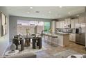 Bright dining area with backyard view, kitchen island, modern table, and stylish chairs set for a comfortable meal at 4242 E Erie St, Gilbert, AZ 85295