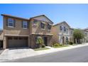 Street view showcasing a modern two-story home with stone details, a garage, and tidy landscaping at 4242 E Erie St, Gilbert, AZ 85295