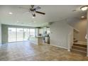 Bright kitchen and dining area with tile floors, stainless appliances, island, and staircase at 4242 E Erie St, Gilbert, AZ 85295