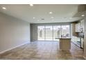 Open-concept living area featuring tile flooring, recessed lighting, and access to the backyard at 4242 E Erie St, Gilbert, AZ 85295